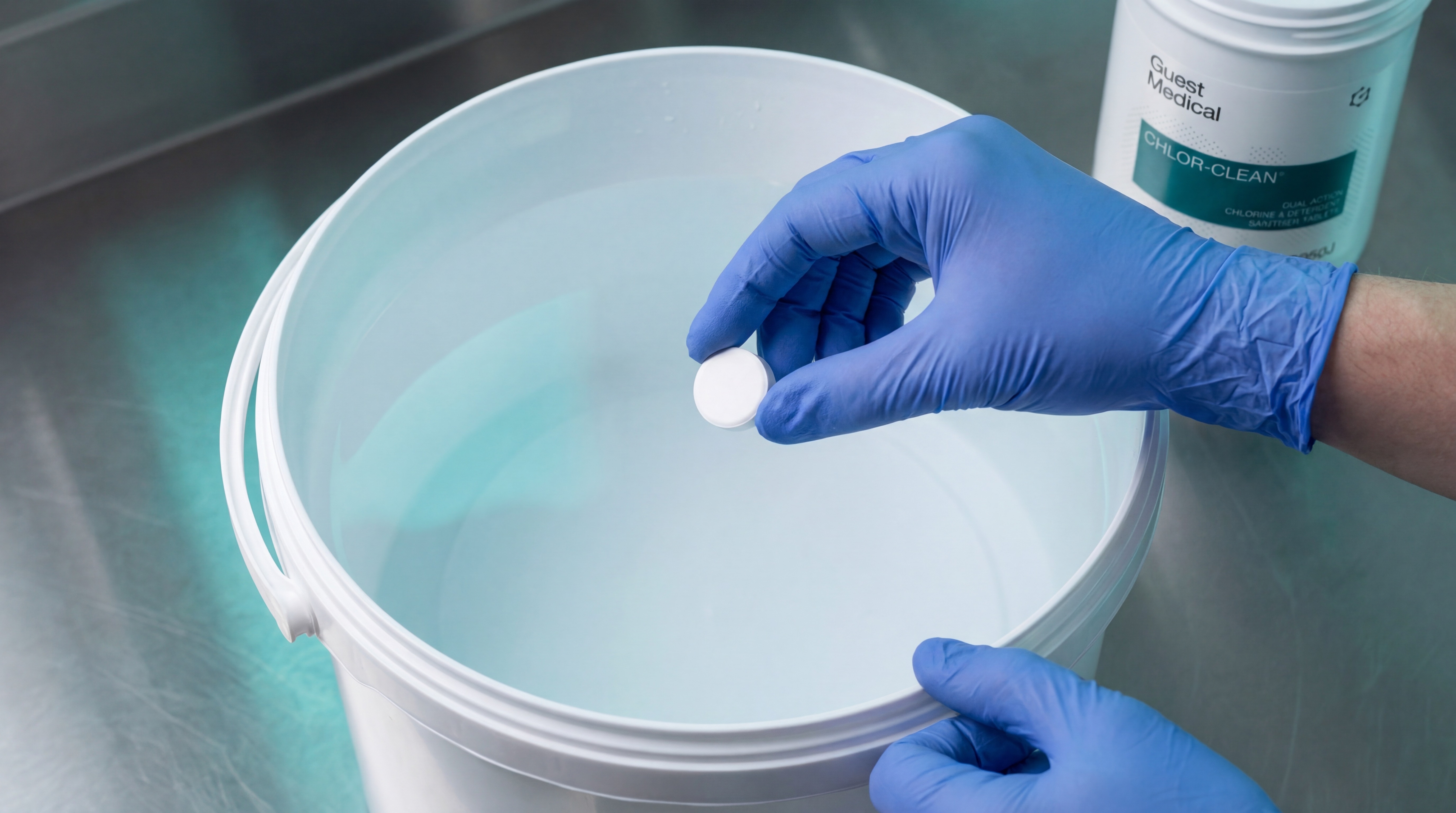 Clinical staff dropping CHLOR-CLEAN tablet into disinfection bucket